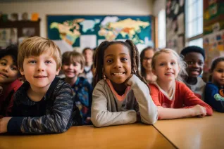 A primary elementary school group of children studying in the classroom. learning and sitting at the desk. young cute kids smiling