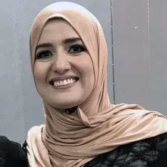 headshot of Rahaf Othman wearing a tan head scarf