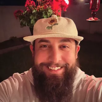 Smiling Arizona teacher Dylan Wince in a cap