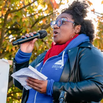 Photo of Angela Bonilla with microphone