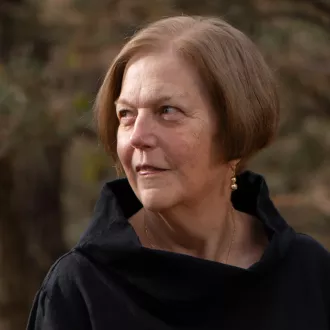 A woman looks off to the side.