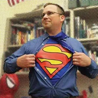 Tim Smyth, high school social studies teacher in Pennsylvania opening his shirt to expose his Superman costume.