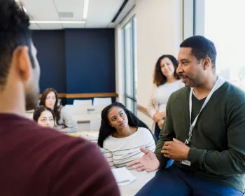 A male teacher talks about gun violence with high school students