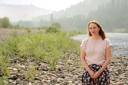 Idaho teacher Janna Privette standing on the shores of a mountain river.