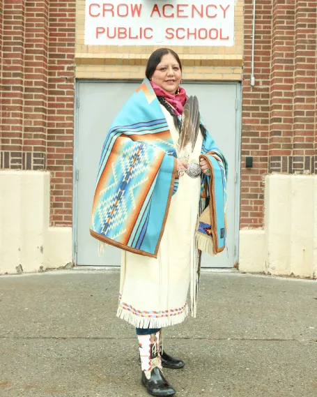 NEA Member, Lucy Real Bird outside of the Crow Agency Public School