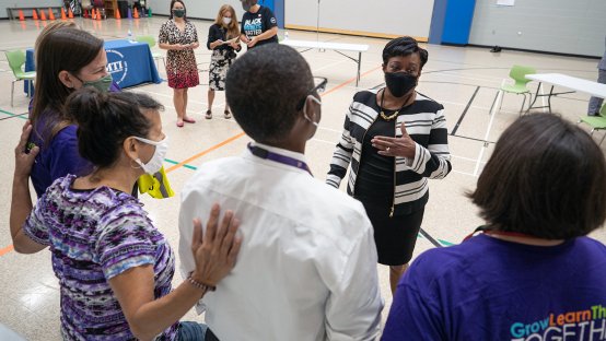 NEA President Becky Pringle visits with educators in the gymnasium at Hawthorne Elementary