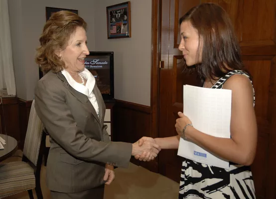 Photo of NC teacher Gina Frutig shaking NC Sen Kay Hagan's hand