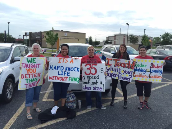 Photo of NC teachers holding protest signs