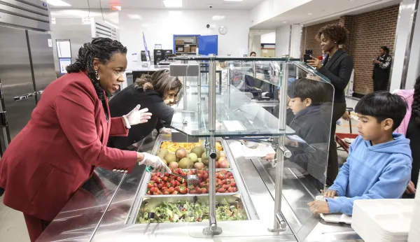 NEA President Becky Pringle serves students a hot lunch during American Education Week.
