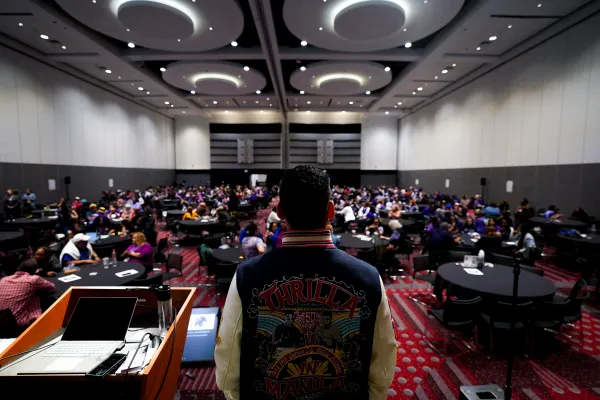 Back view of speaker, full room of RA delegates