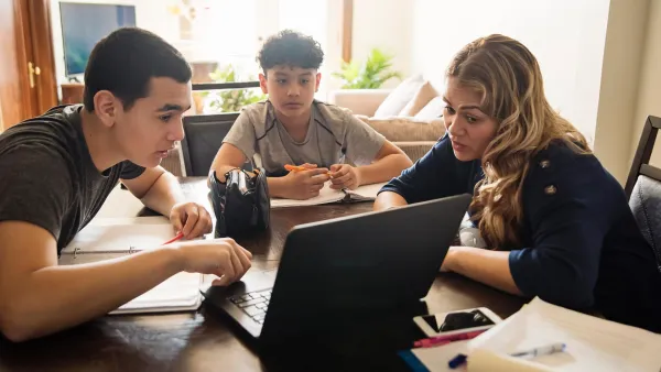 A mom home-schools her sons at the kitchen table