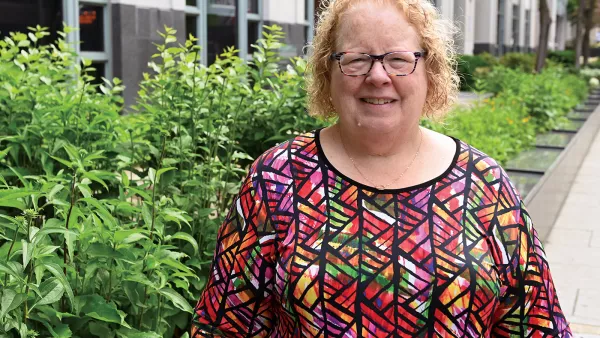 Meg Gruber stands near flowers outside the NEA building in Washington DC
