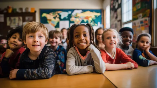 A primary elementary school group of children studying in the classroom. learning and sitting at the desk. young cute kids smiling