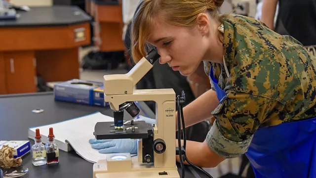 Student looking through microscope