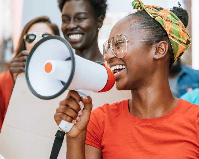 Girl with megaphone in a group of people