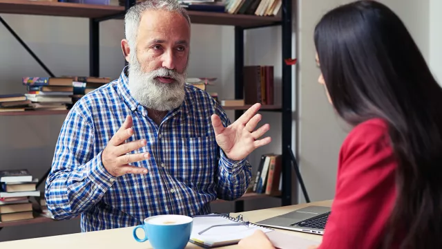 retiree talks to young educator
