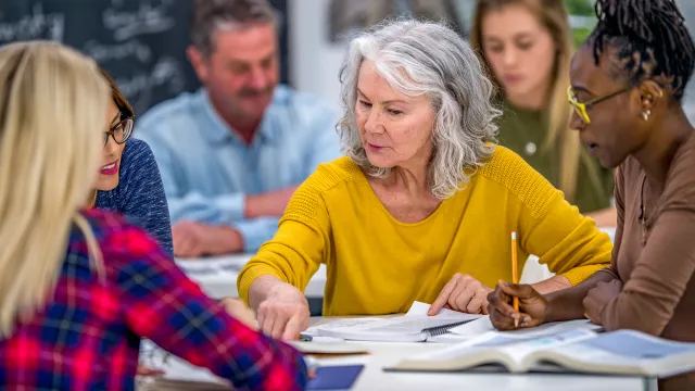 Individuals working together around a table