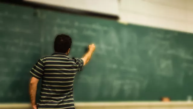 Teacher at Chalkboard