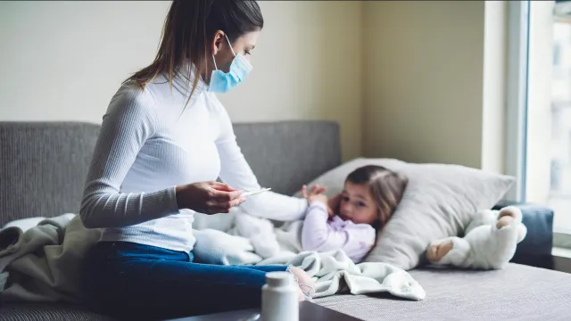 A mom tends to a sick child
