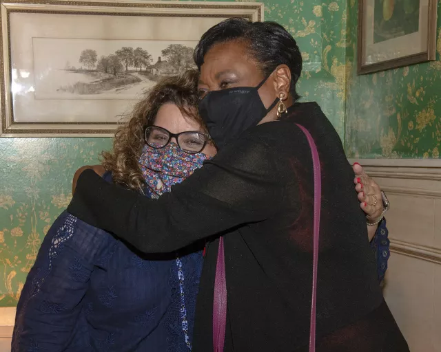 Becky hugs fellow educator