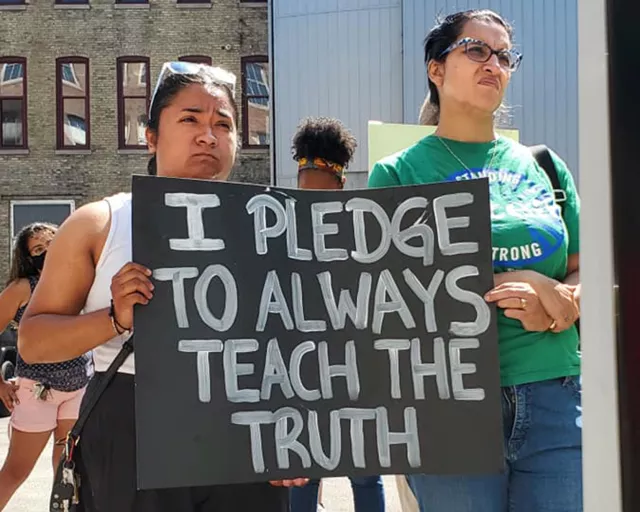 two teachers with sign that says I pledge to always teach the truth