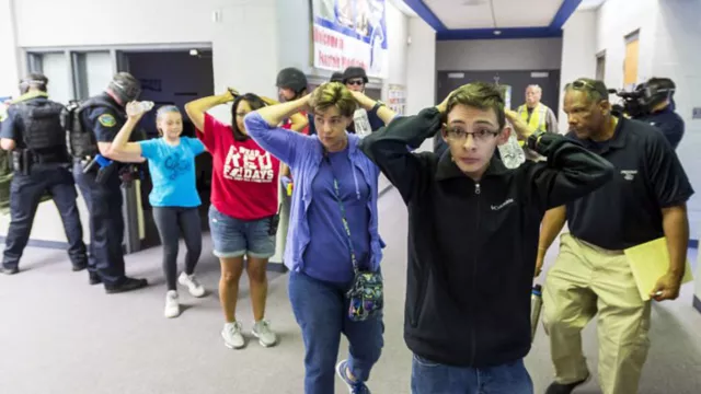 "Victims" are led out as members of the Fountain Police Department take part in an Active Shooter Response Training exercise at Fountain Middle School in Fountain Colo.