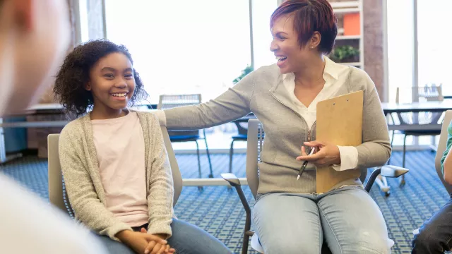 School counselor supports a young student during a group session