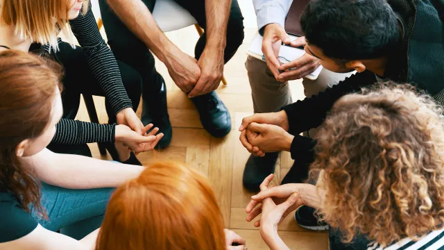 teenagers in group therapy session sitting in circle