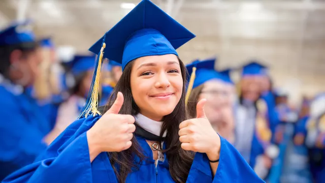 female high school graduate in cap and gown