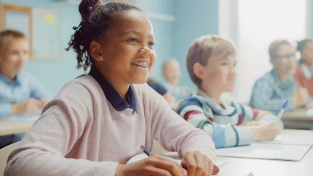 Smiling kid in class