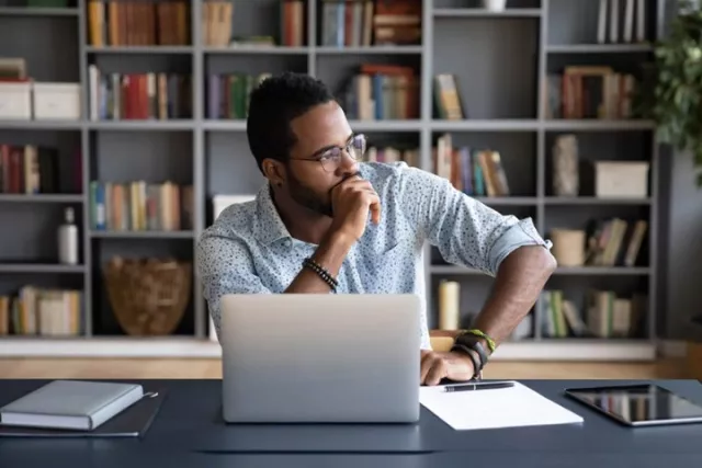 Man at desk looking stressed