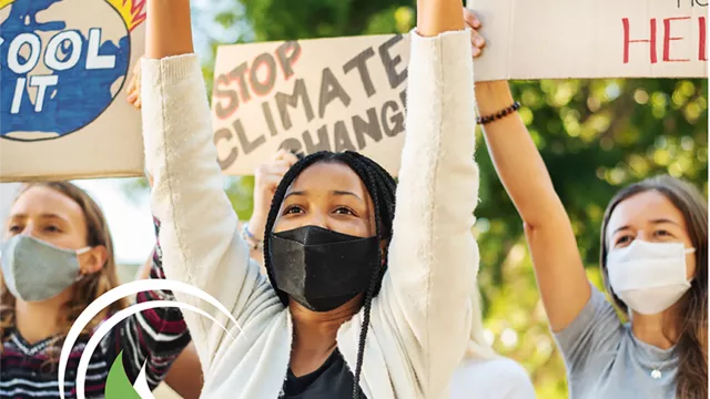Activists holding signs about stopping climate change