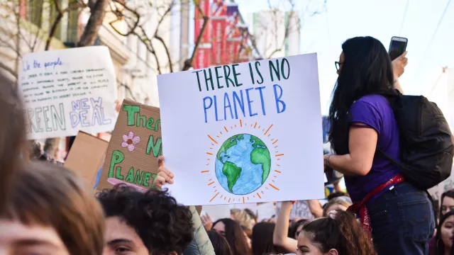 Activist holding a sign that reads, "There is No Planet B"