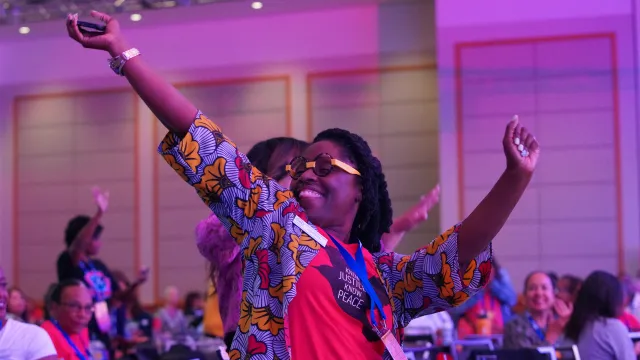 Woman with stretched out arms, expressing joy.