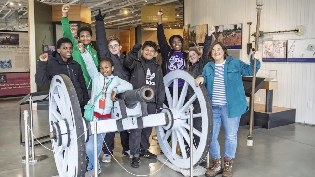Teacher with students at historical museum