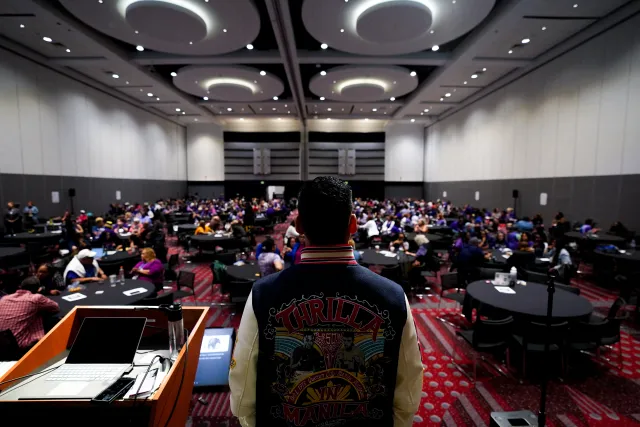 Back view of speaker, full room of RA delegates