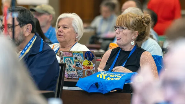 Two women attendees at the NEA-Retired conference sit and listen to the meeting proceedings