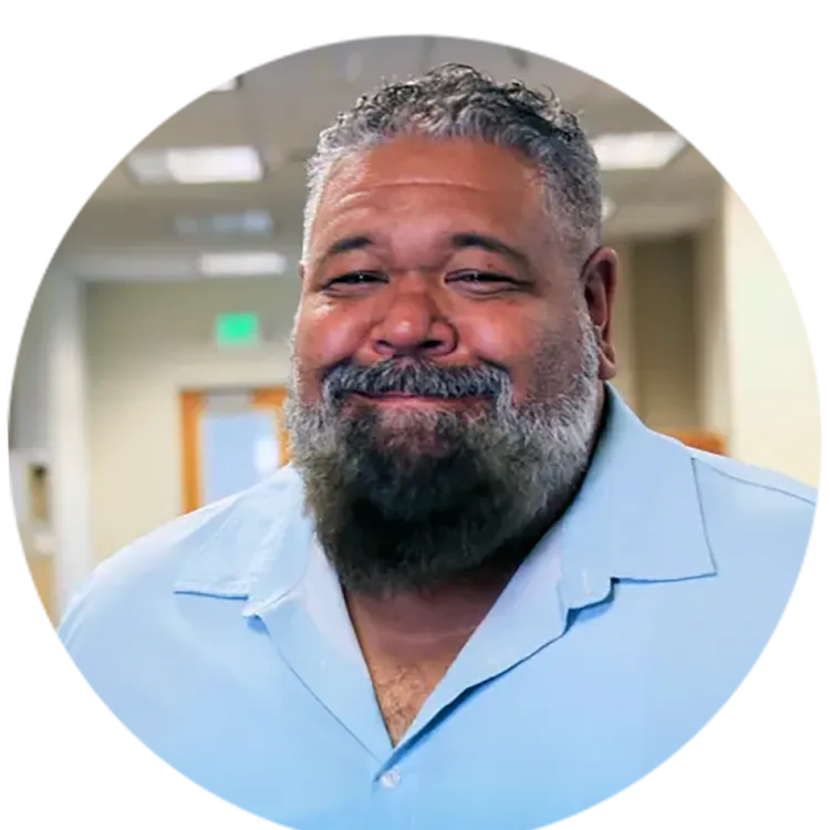 Headshot of Ric Calhoun wearing a light blue shirt.