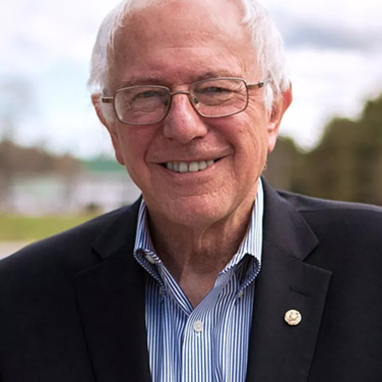 Bernie Sanders wearing glasses and a smile.
