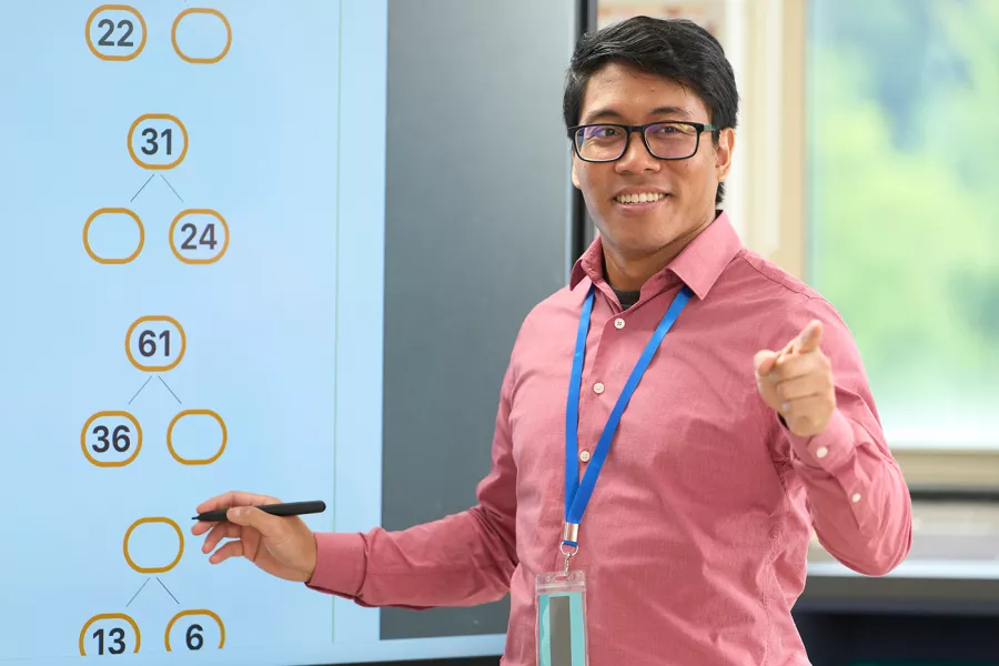 Male math teacher with glasses teaching a lesson
