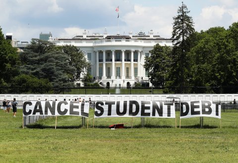 Signs saying cancel student debt outside the White House.