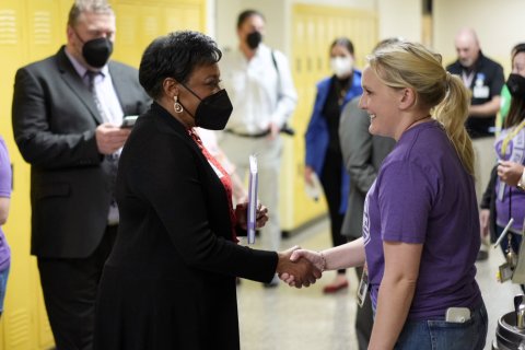 President Pringle meets a teacher at Lexington Traditional Magnet School