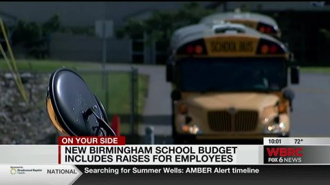 Bus with news ticker saying, "On your side: New Birmingham School Budget Includes Raises for Employees"