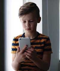 Boy using smart phone.