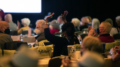 Delegates to the 2022 NEA-Retired Annual Meeting cheer a speaker.