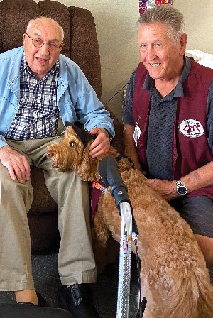 Alen Ritchie and therapy dog Elliott visit a nursing home. 