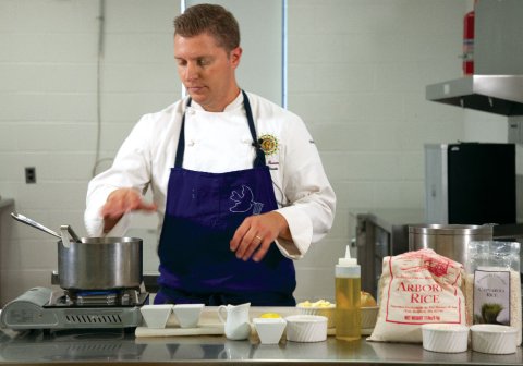 Culinary Arts Teacher Adam Monette cooking in the classroom kitchen