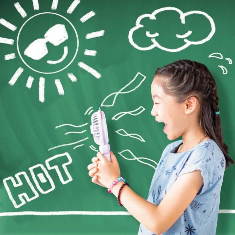 Young Asian girl holding a portable fan in front of a chalkboard with symbols of heat drawn.