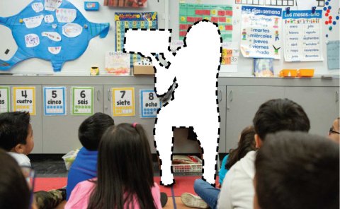 Students in a classroom with teacher cutout.