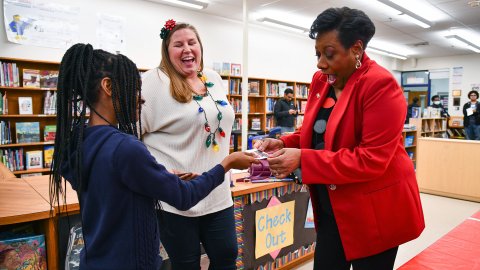 NEA President Becky Pringle receives a Read Across America sticker from a student.